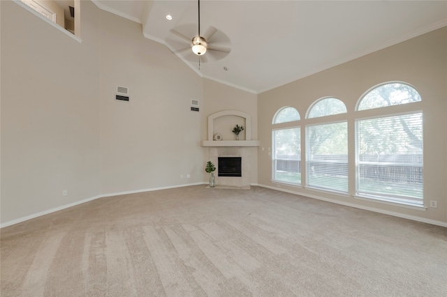 unfurnished living room with light carpet, a healthy amount of sunlight, ceiling fan, and a tiled fireplace