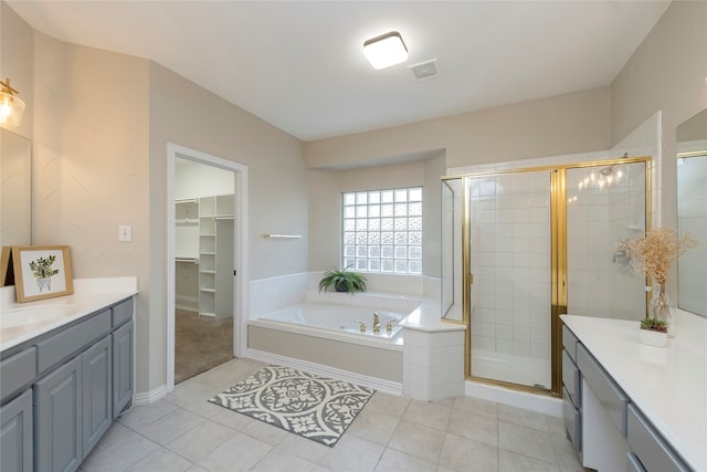 bathroom featuring shower with separate bathtub, tile patterned floors, and vanity