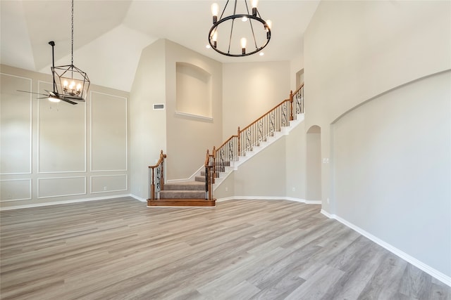 entrance foyer featuring high vaulted ceiling, ceiling fan, and light hardwood / wood-style flooring