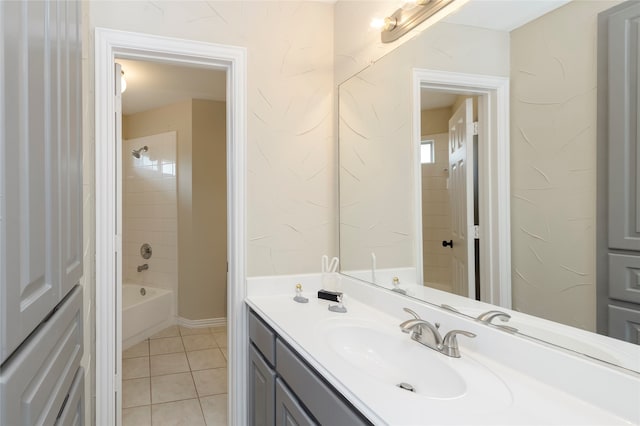 bathroom with tile patterned floors, vanity, and tiled shower / bath combo