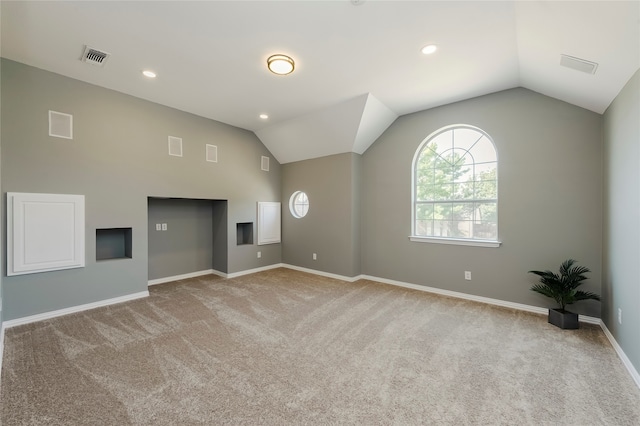 unfurnished living room featuring lofted ceiling and light colored carpet