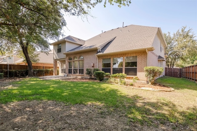 back of property featuring a patio and a lawn