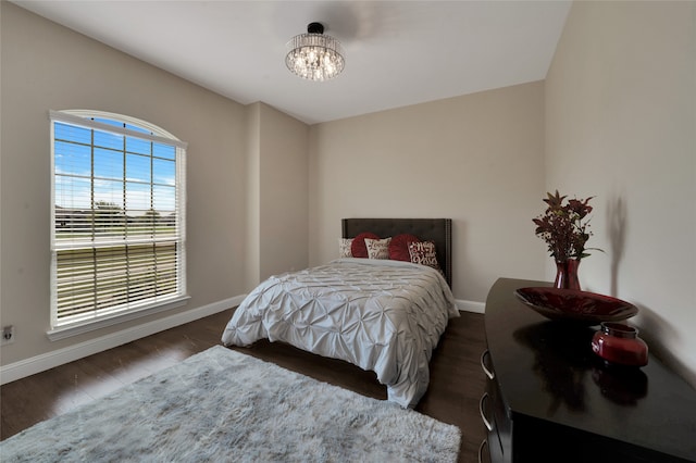 bedroom with dark hardwood / wood-style flooring