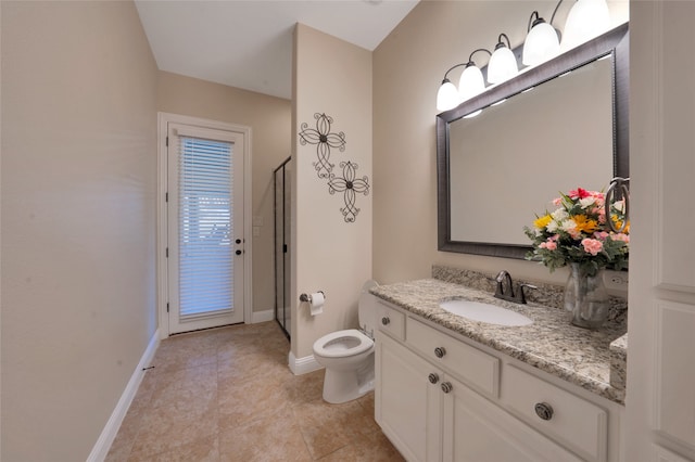 bathroom featuring tile patterned flooring, walk in shower, vanity, and toilet