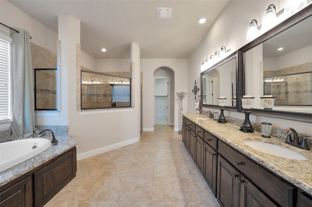 bathroom featuring shower with separate bathtub, tile patterned floors, and vanity