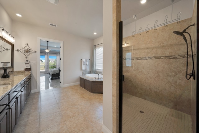 bathroom featuring tile patterned flooring, separate shower and tub, and vanity