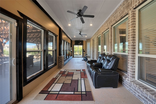 sunroom with ceiling fan and plenty of natural light