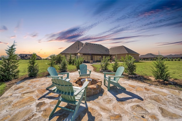 patio terrace at dusk with a yard and a fire pit