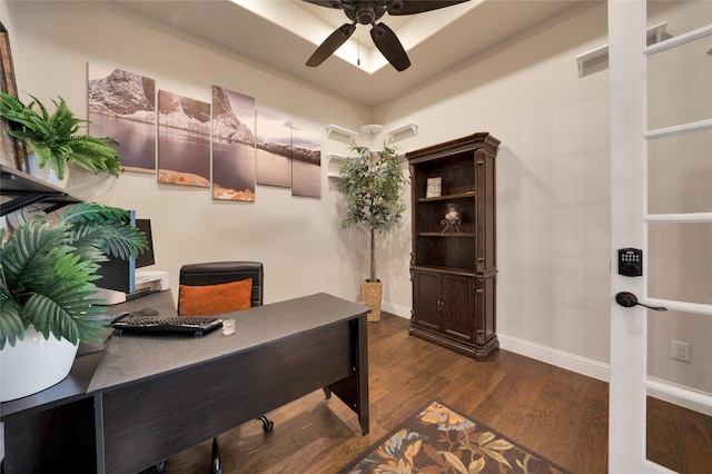 home office with ceiling fan and dark hardwood / wood-style flooring