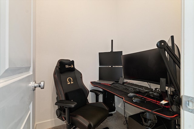 carpeted home office featuring baseboards