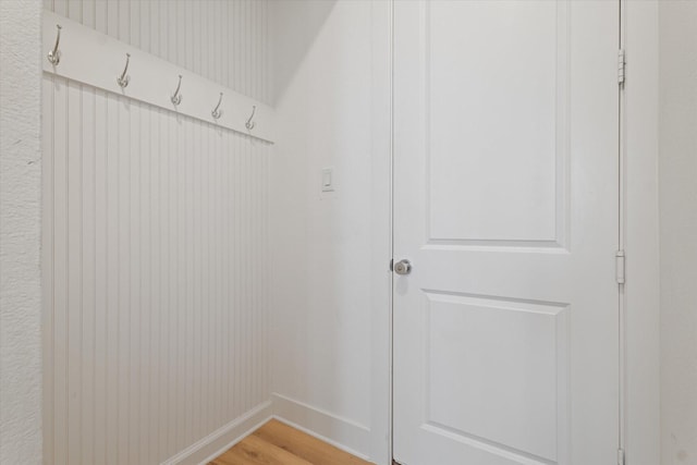 mudroom featuring light wood-style flooring and baseboards