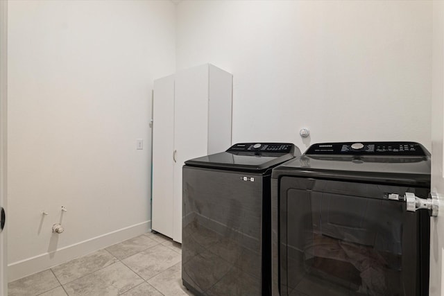 417 Sunnyridge Ln, Little Elm, TX 76227 - clothes washing area with washing machine and clothes dryer, light tile patterned floors, and baseboards