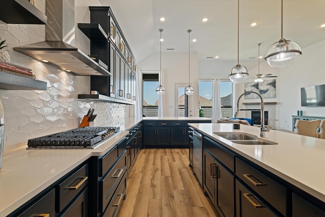 kitchen with open shelves, appliances with stainless steel finishes, wall chimney exhaust hood, and light countertops