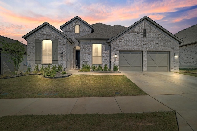 french country inspired facade with a garage and a lawn