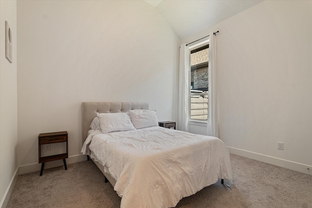 bedroom featuring baseboards, carpet floors, and vaulted ceiling