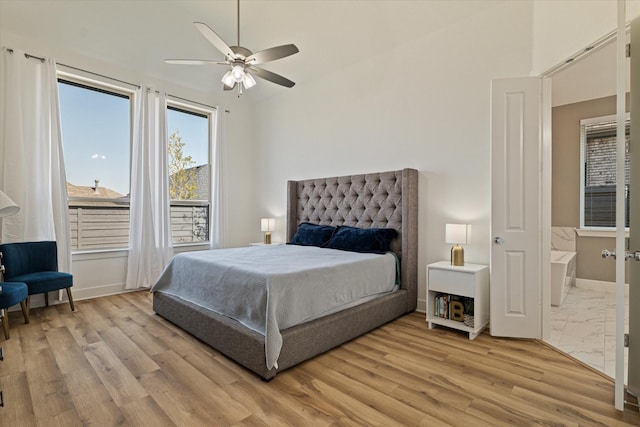 bedroom with light wood-style flooring, baseboards, and ceiling fan