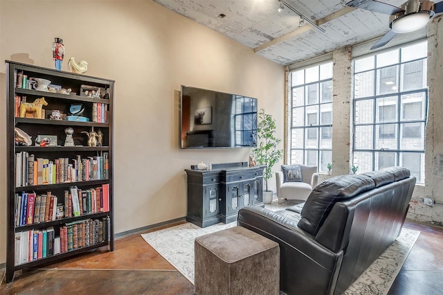 living room featuring ceiling fan and concrete floors