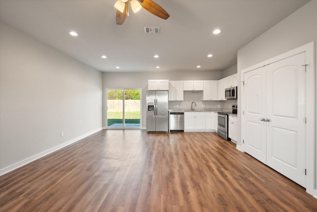 kitchen with ceiling fan, sink, dark wood-type flooring, white cabinets, and appliances with stainless steel finishes