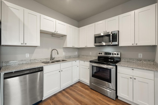 kitchen featuring stainless steel appliances, white cabinetry, dark wood-type flooring, and sink