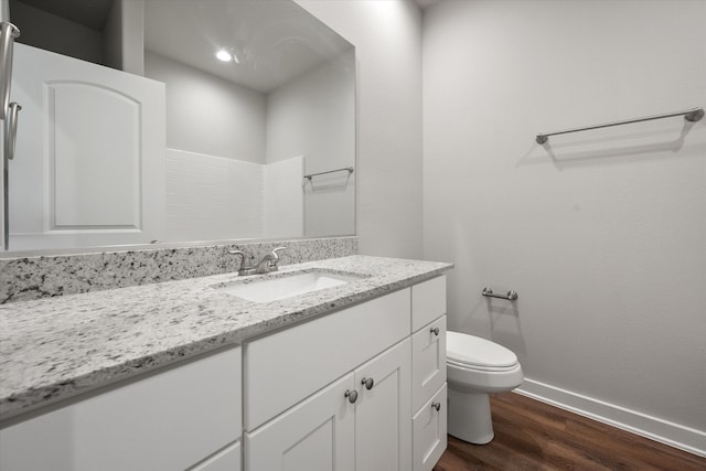 bathroom featuring vanity, toilet, and wood-type flooring