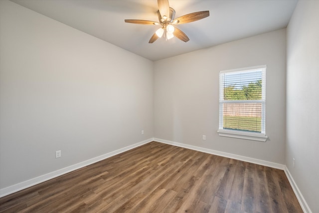 empty room featuring ceiling fan and dark wood-type flooring