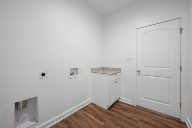 washroom featuring hookup for an electric dryer, washer hookup, dark hardwood / wood-style flooring, and cabinets