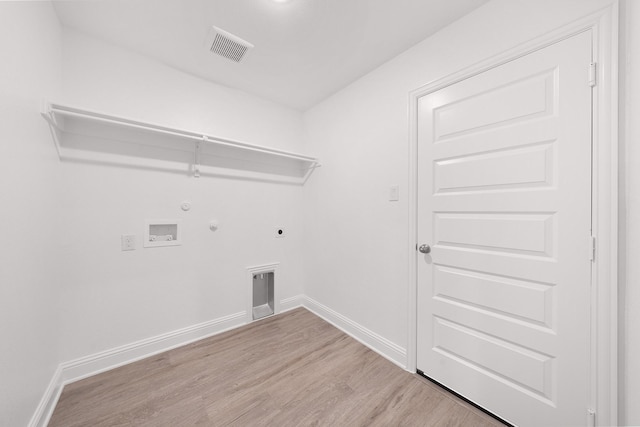 laundry area with gas dryer hookup, washer hookup, wood finished floors, laundry area, and electric dryer hookup