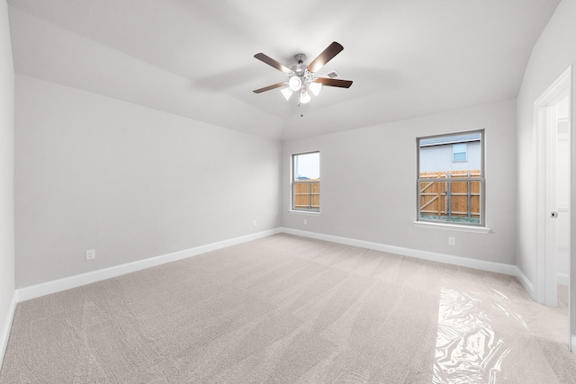 unfurnished room featuring a ceiling fan, baseboards, and light colored carpet