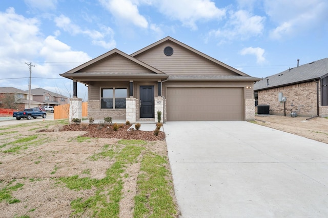 ranch-style home with driveway, brick siding, a garage, central AC, and a porch
