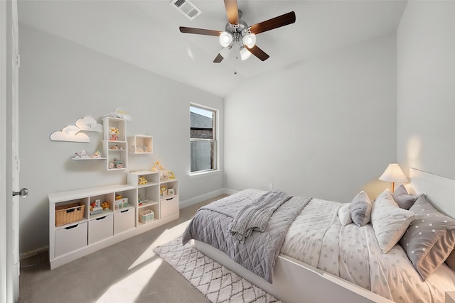 carpeted bedroom featuring a ceiling fan, visible vents, baseboards, and lofted ceiling