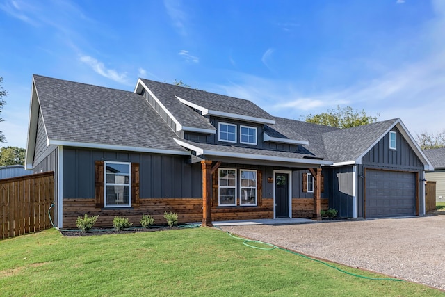 craftsman-style house featuring a garage, a porch, and a front yard