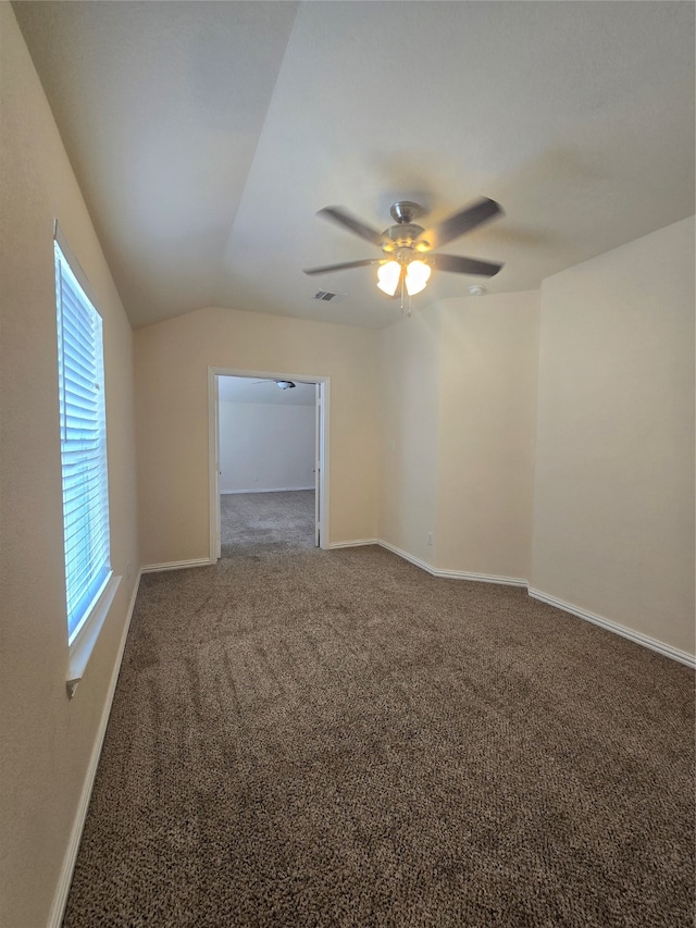 spare room with lofted ceiling, carpet, and ceiling fan