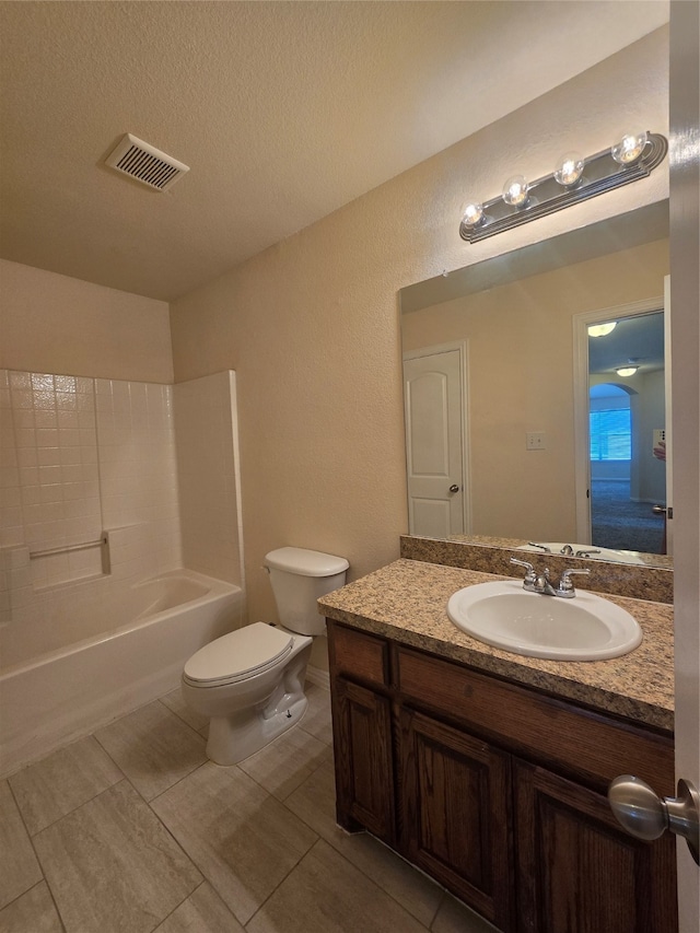 full bathroom featuring bathtub / shower combination, a textured ceiling, toilet, vanity, and tile patterned flooring