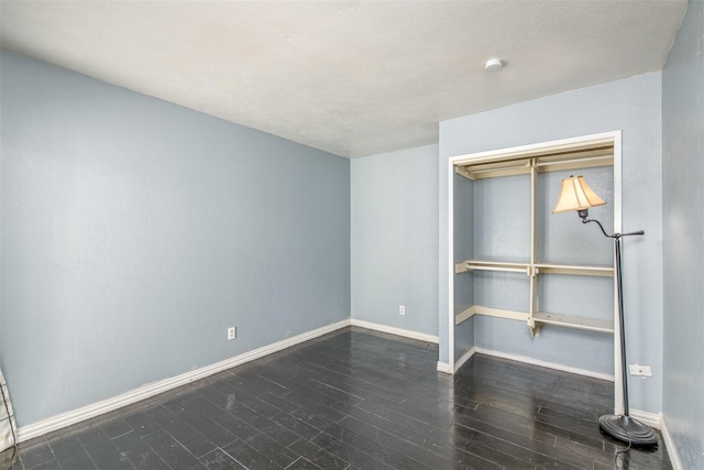 unfurnished bedroom featuring dark hardwood / wood-style floors