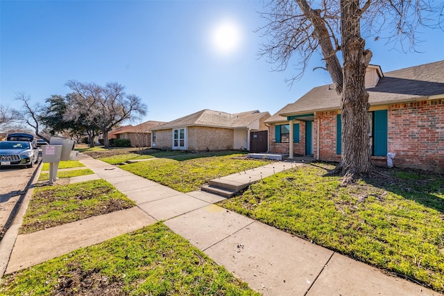 ranch-style home with a front lawn