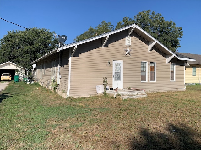 rear view of house featuring a yard