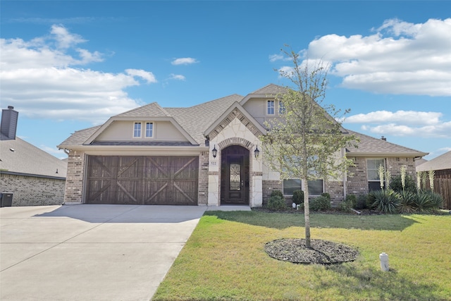 view of front of home featuring a front yard and central AC