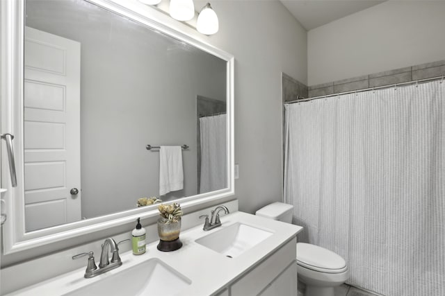 bathroom featuring a shower with curtain, vanity, and toilet