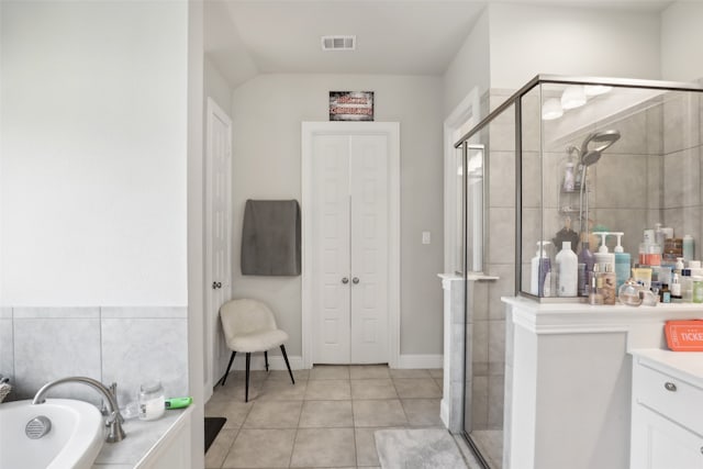 bathroom featuring vanity, shower with separate bathtub, and tile patterned floors