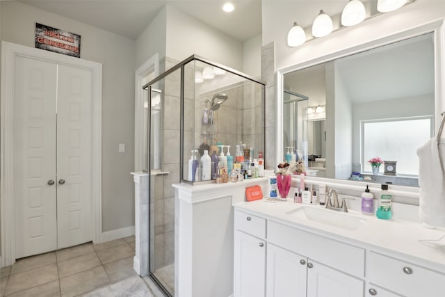 bathroom featuring tile patterned flooring, vanity, and a shower with shower door