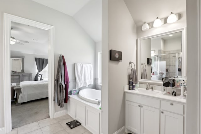 bathroom with ceiling fan, vanity, lofted ceiling, plus walk in shower, and tile patterned floors