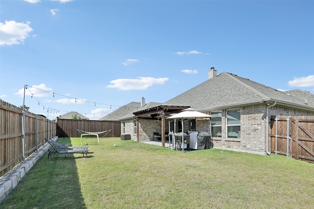 rear view of property featuring a yard and a patio