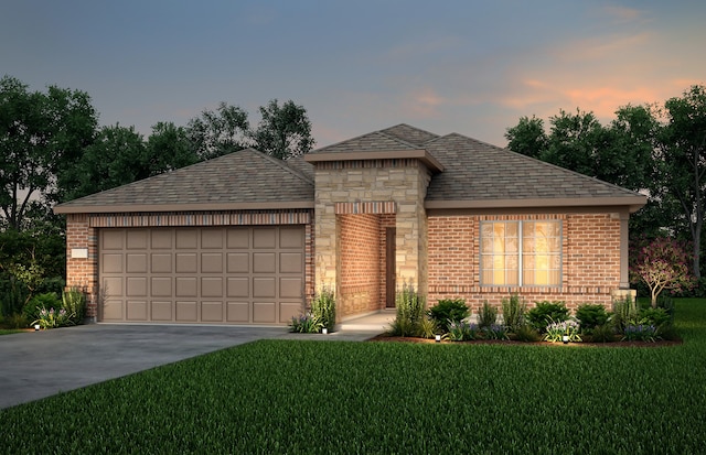 view of front of property with a yard and a garage