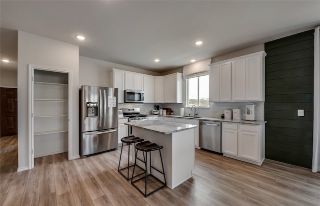 kitchen with sink, white cabinetry, a center island, and stainless steel appliances