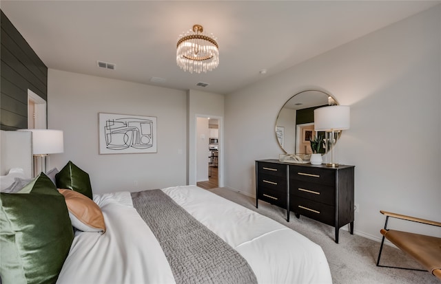 bedroom with light carpet and an inviting chandelier