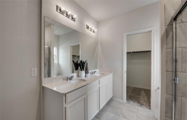 bathroom featuring tile patterned flooring, walk in shower, and vanity