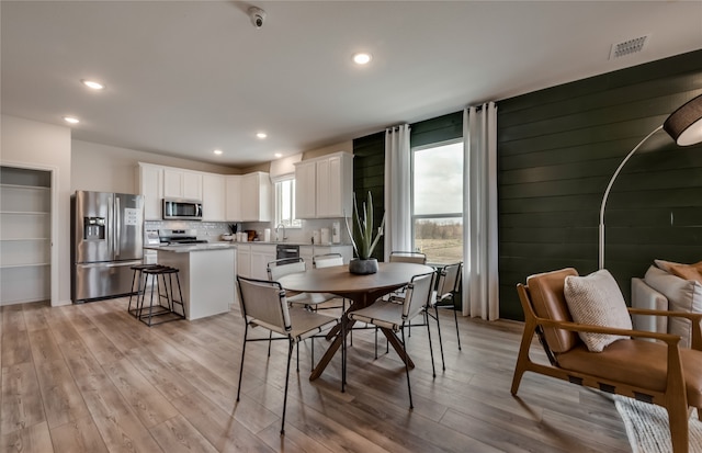 dining space featuring light hardwood / wood-style floors and sink