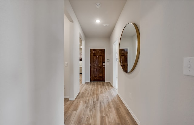 hall with light wood-type flooring