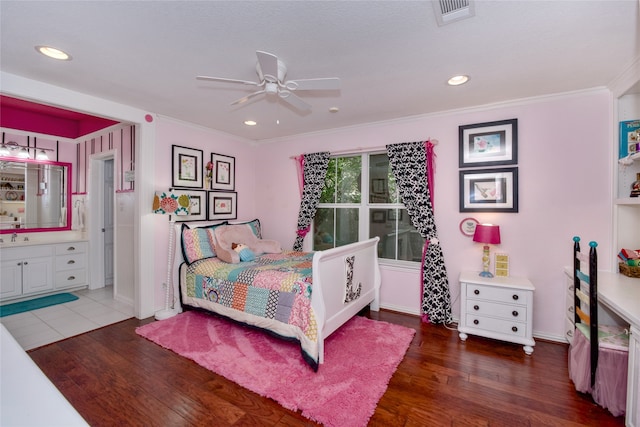 bedroom featuring ceiling fan, crown molding, sink, dark hardwood / wood-style floors, and connected bathroom