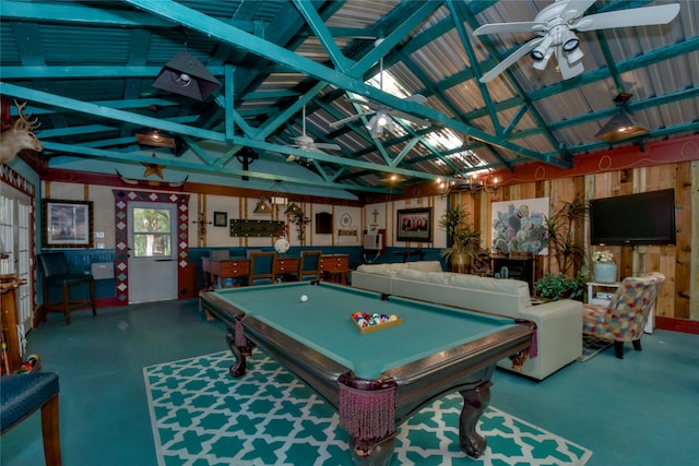 game room with pool table, wood walls, lofted ceiling with beams, ceiling fan, and concrete floors